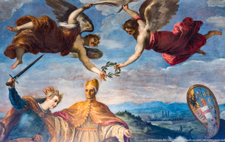 Robed Venetian ruler beneath flying allegorical figures, with a sword-bearing woman and large heraldic shield.
