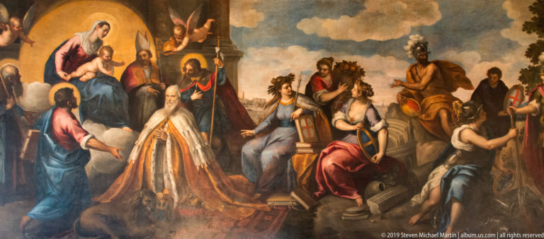 Kneeling doge in gold robes before enthroned allegorical figures, with saints and attendants gathered around.