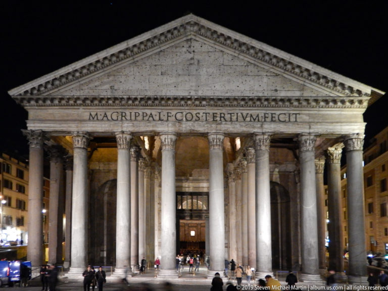Frontal nighttime view of the Pantheon’s illuminated pediment, Agrippa inscription, Corinthian portico, and entrance.