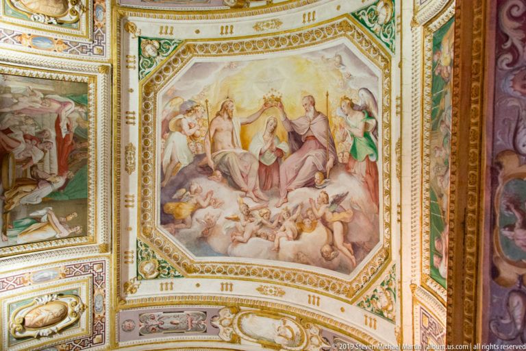 Octagonal ceiling fresco with an enthroned female figure surrounded by deities, attendants, and airborne figures.