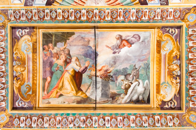 Religious fresco with kneeling robed figure, descending heavenly figure, flaming altar, witnesses, and an animal.