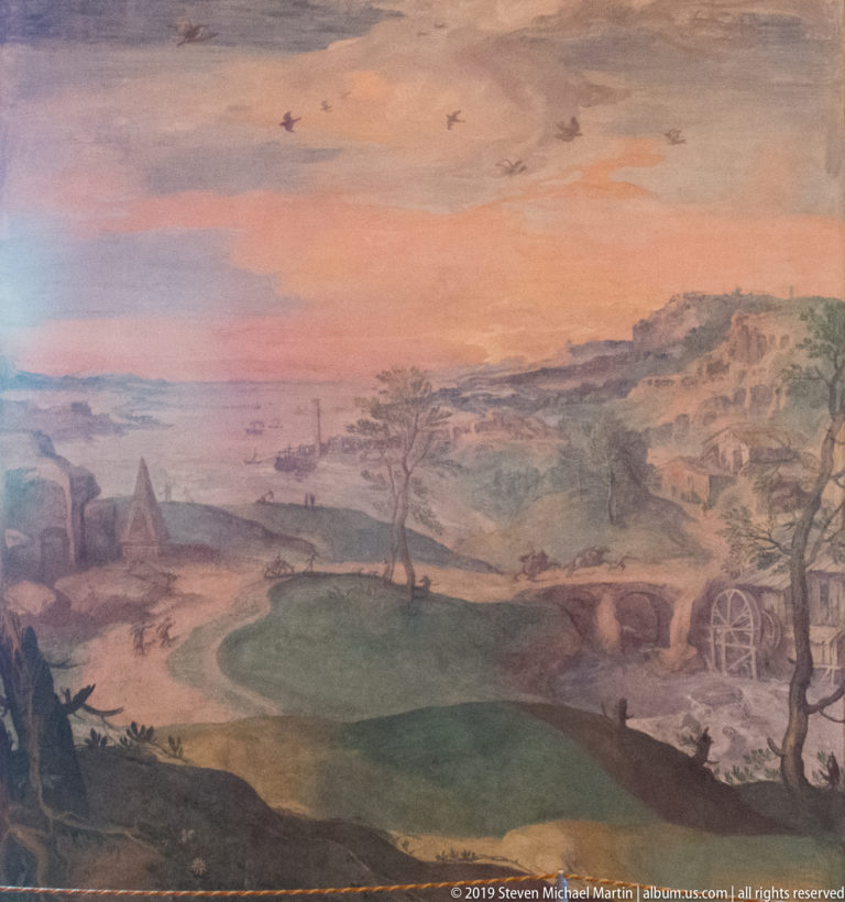 Pastoral fresco landscape with winding water, distant hills, sparse trees, birds, and a large wheel-like form.