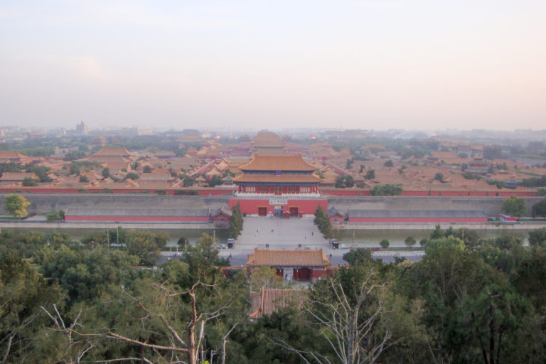 Wide elevated panorama of the Forbidden City from Jingshan, showing the expansive imperial palace aligned along its central axis.