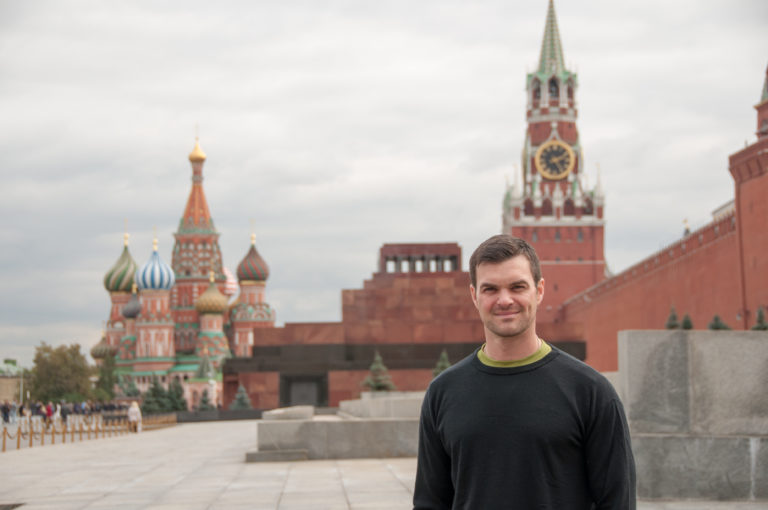 Visitor centered on Red Square with Lenin Mausoleum, Spasskaya Tower, and Saint Basil’s Cathedral in the background.