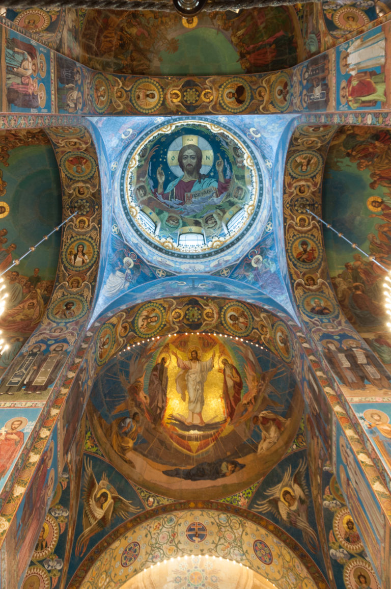Symmetrical upward view of Pantocrator and Transfiguration mosaics connected by arches, medallions, and narrative panels.