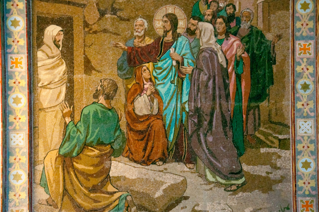 Close-up of a biblical mosaic showing Christ among kneeling and standing figures, framed by a patterned border.