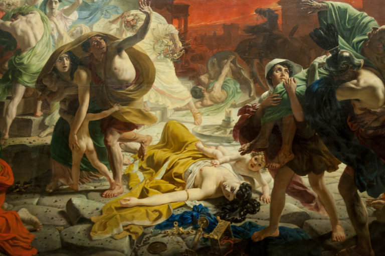 Detail of The Last Day of Pompeii with a fallen woman in yellow surrounded by people fleeing beneath a fiery red sky.