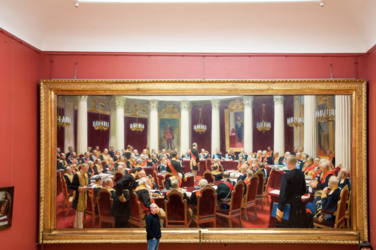 Ilya Repin’s 1903 State Council painting, with Nicholas II and officials seated around a horseshoe-shaped table in the Mariinsky Palace.