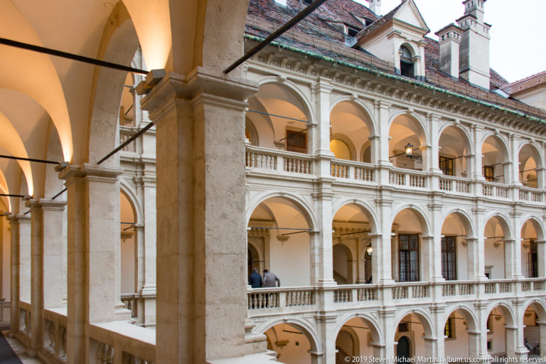 Three levels of pale Renaissance arcades and balustrades enclosing the courtyard of the Graz Landhaus.