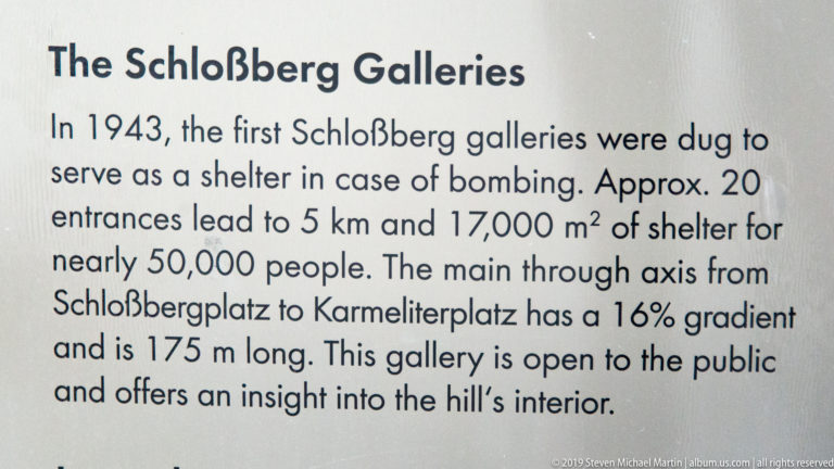 Close view of English interpretive text describing the 1943 Schlossberg Galleries air-raid shelter tunnels.