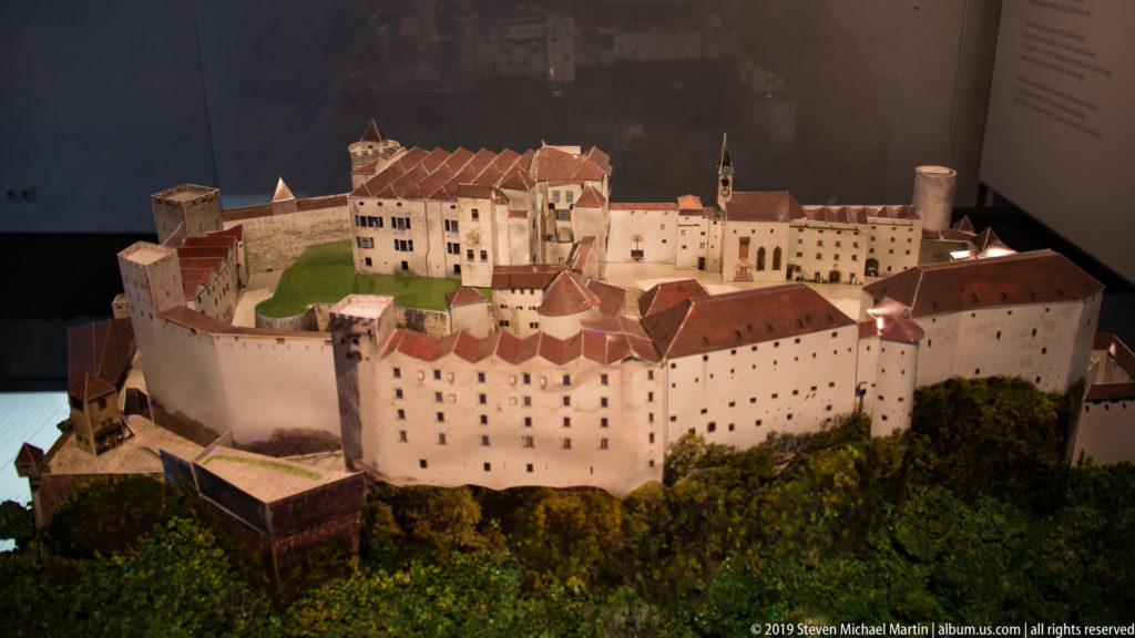 Scale model of Hohensalzburg Fortress showing courtyards, towers, red-tiled roofs, curtain walls, and defensive works.