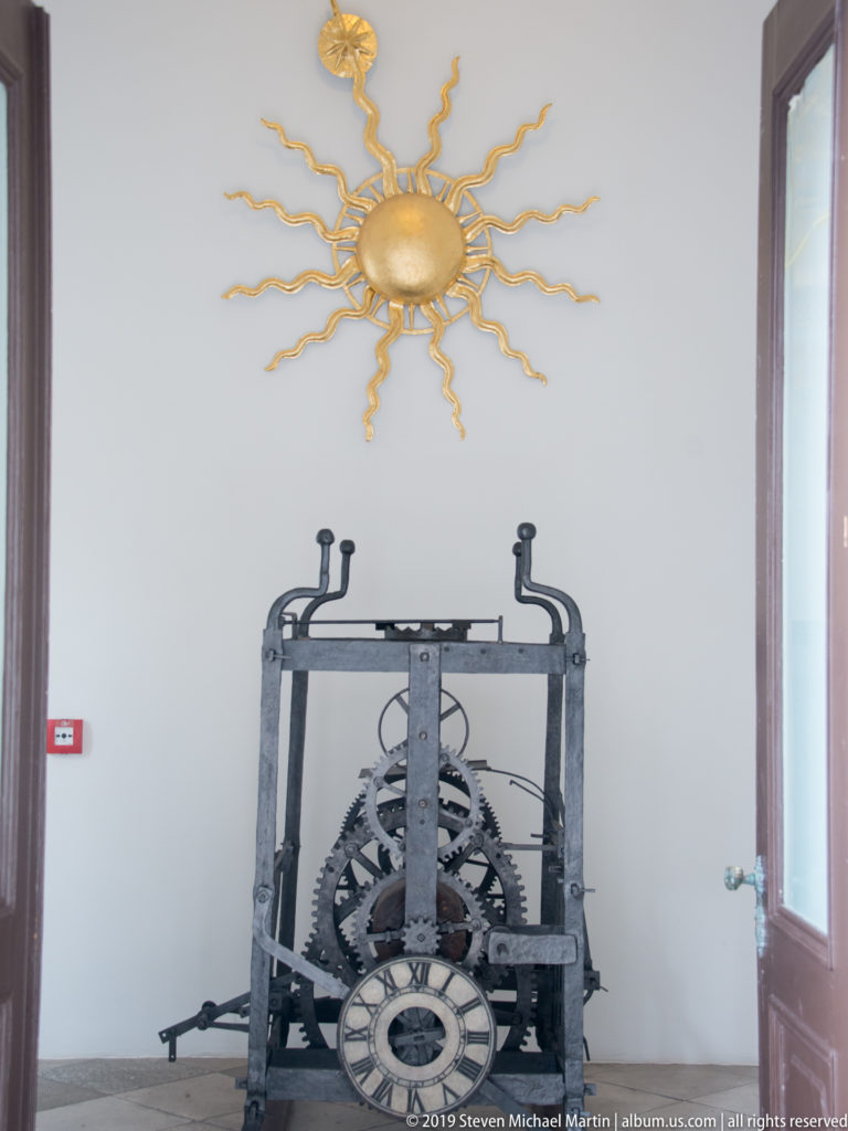 Pasko Baletin’s 1781 iron clock mechanism displayed below the sun-shaped “Hobotnica” dial from Dubrovnik’s City Bell Tower.