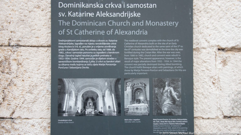Bilingual interpretive panel titled Dominican Church and Monastery of St Catherine of Alexandria mounted on a stone wall.