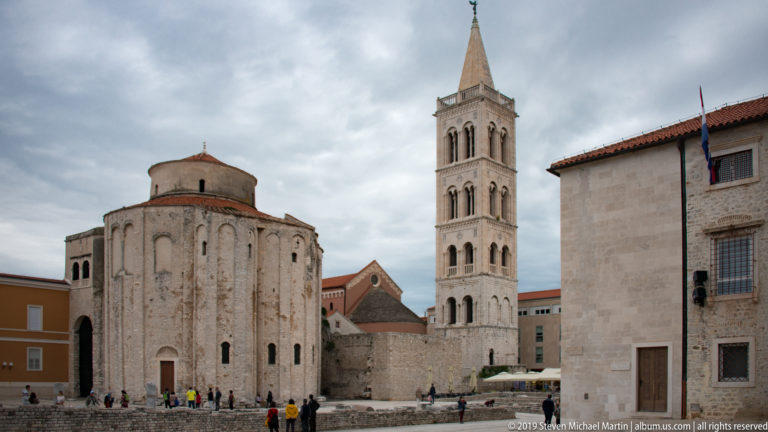 Church of St. Donatus with St. Anastasia Cathedral bell tower rising behind in Zadar’s historic center.