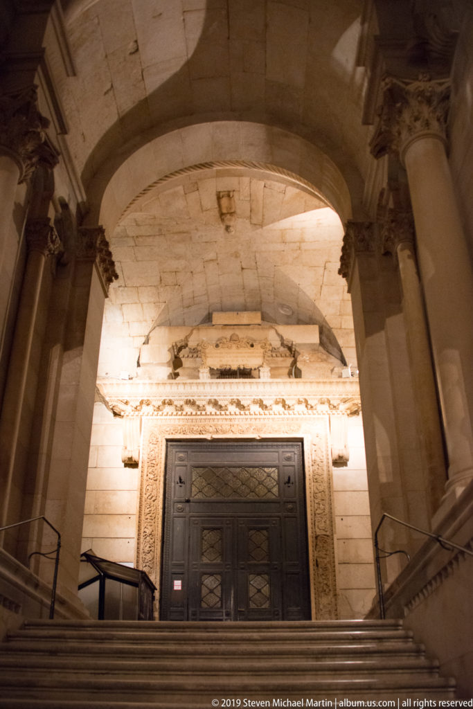 Broad night view of steps and columns leading to the illuminated entrance of Saint Domnius Cathedral in Split.