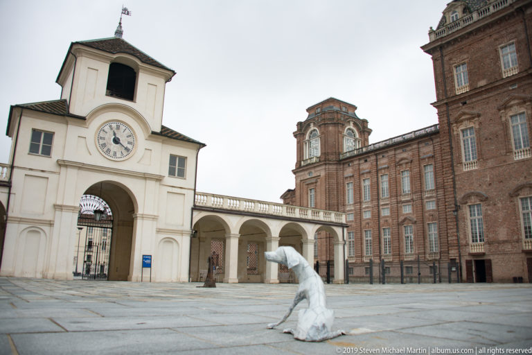 La Venaria Reale’s clock gate and Court of Honor with dog sculptures from Velasco Vitali’s 2019 Branco installation.