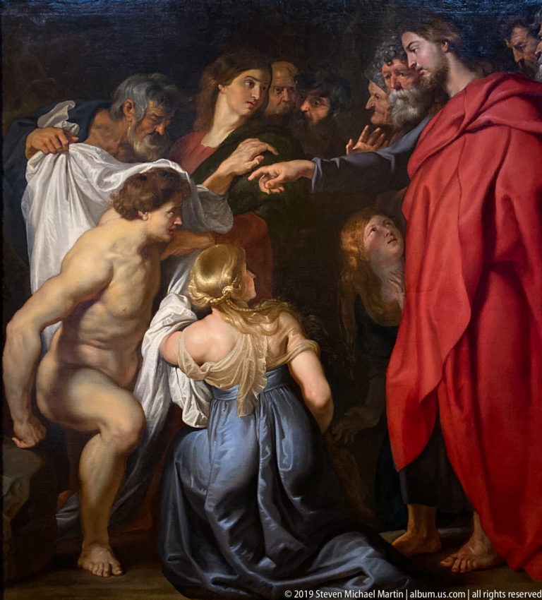Dramatic multi-figure religious painting with a nearly nude central man and a red-robed figure, shown in La Venaria Reale’s Annunciazione e Natività exhibition.