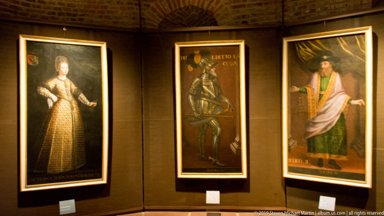 Three full-length Savoy portraits showing a richly dressed woman, an armored man, and a robed male figure.