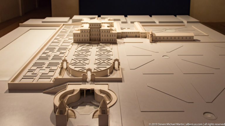 Large site model showing palace buildings, formal parterres, avenues, and geometric garden compartments.