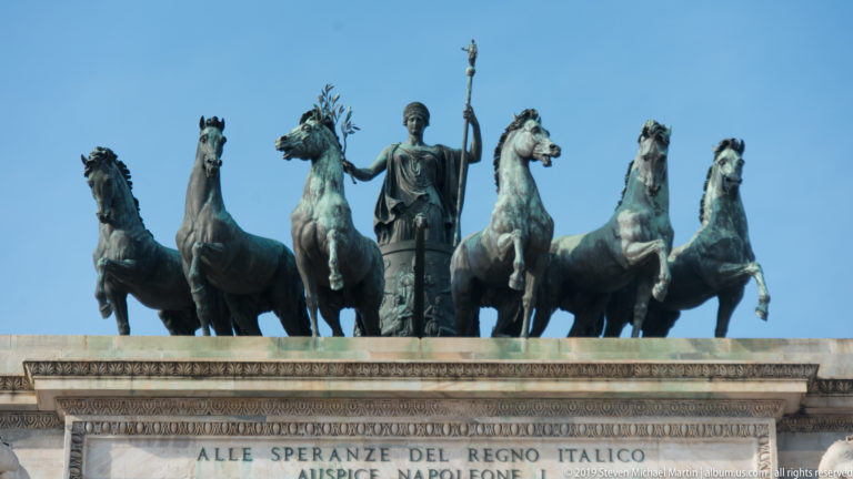 Six bronze horses with the central figure of Peace crowning Milan’s Arco della Pace.