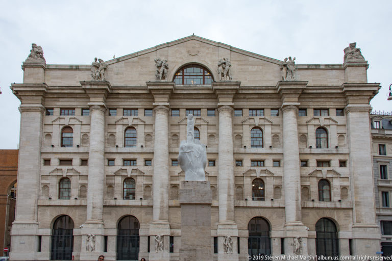 Palazzo Mezzanotte, home of Borsa Italiana, with Maurizio Cattelan’s L.O.V.E. sculpture centered in Piazza Affari.