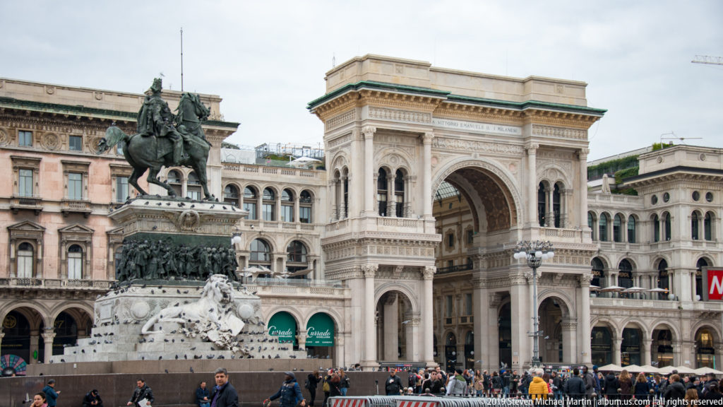 Victor Emmanuel II equestrian monument in front of the arched entrance to the Galleria Vittorio Emanuele II.