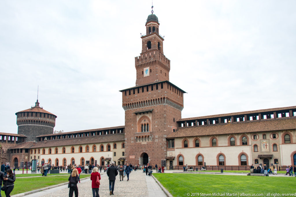 Torre del Filarete rising above the brick walls and courtyard of Milan’s Sforza Castle.