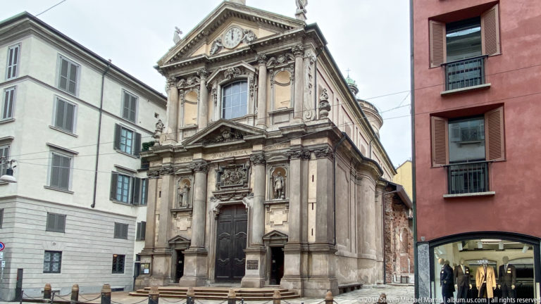 Street façade of San Maurizio al Monastero Maggiore with pilasters, pediment, and tall central doorway.