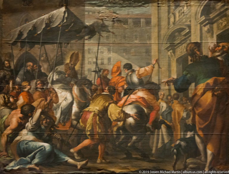 Crowded religious painting with struggling figures, soldiers, horses, and onlookers before an architectural background.