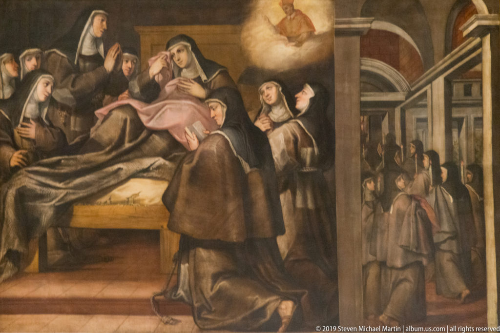 Religious painting of a reclining figure surrounded by veiled women and a kneeling attendant in an interior setting.