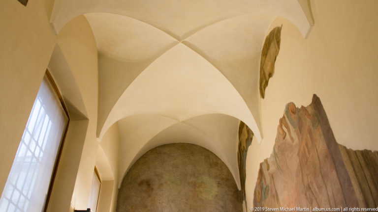 Fragmentary Renaissance wall painting preserved on pale plaster beneath a groin-vaulted ceiling in Santa Maria delle Grazie.