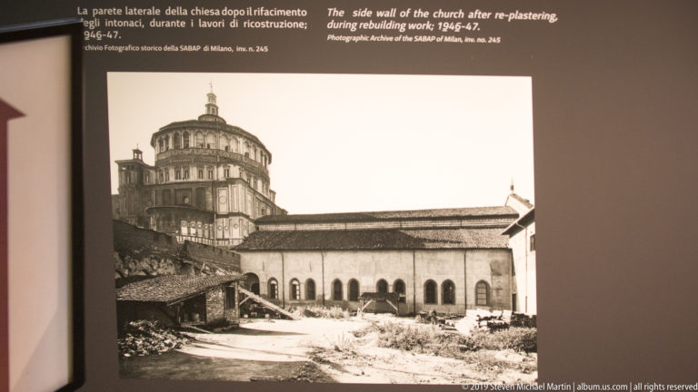 Archival view of a re-plastered church side wall with arched windows and the Santa Maria delle Grazie tribune behind.