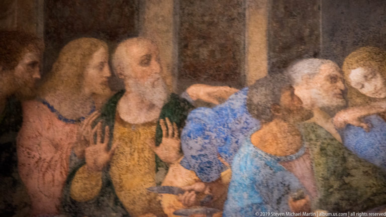 Andrew raises both hands beside Judas, Peter, and the youthful John in a close detail of The Last Supper.