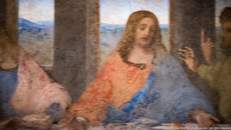 Christ centered in red and blue, with James the Greater and Thomas gesturing to his right in The Last Supper.