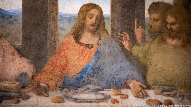 Christ seated at the table beside Thomas with raised finger and James the Greater gesturing in Leonardo’s The Last Supper.
