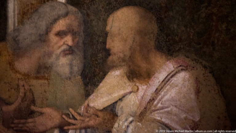 Jude Thaddeus gestures toward the white-bearded Simon at the far right of Leonardo’s The Last Supper.