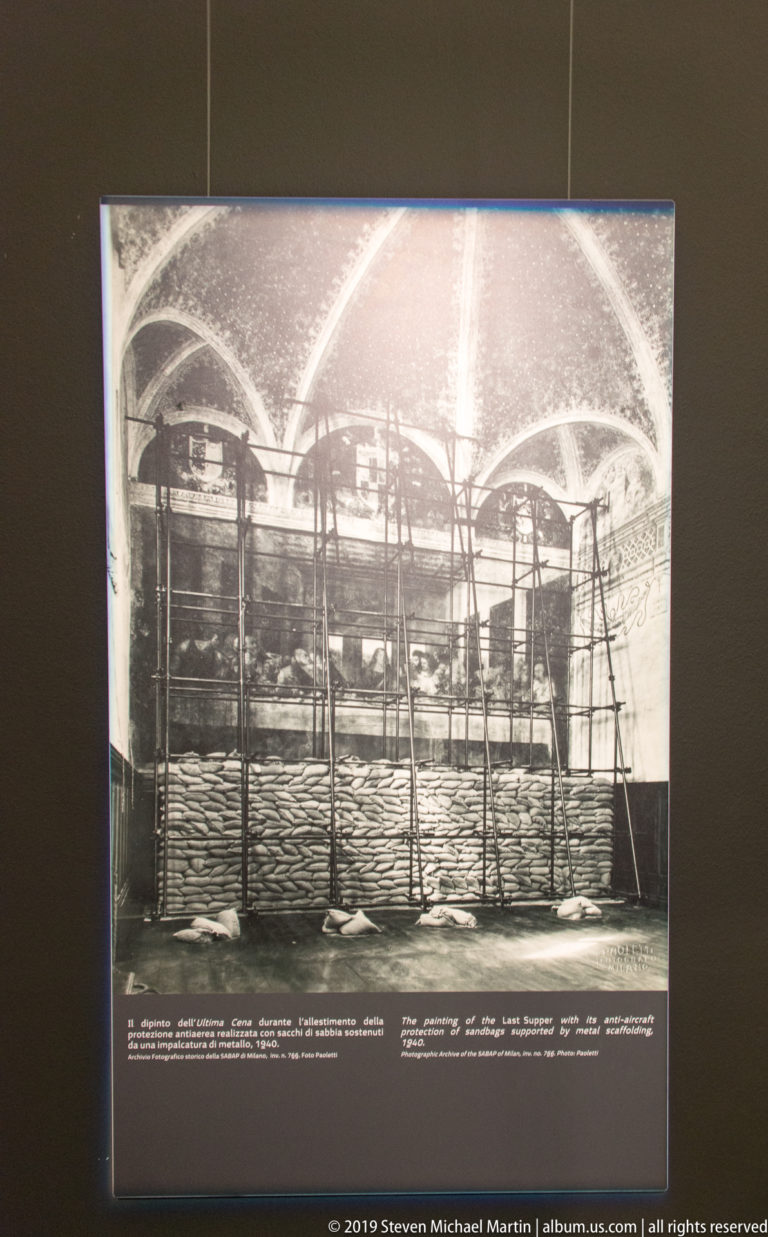 Historical interior view of the vaulted refectory with a wall-high barrier of sandbags and scaffolding protecting The Last Supper.