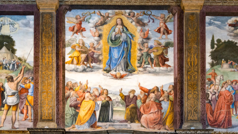 Assumption fresco with the Virgin rising in a golden aura among angels above apostles gathered around the tomb.