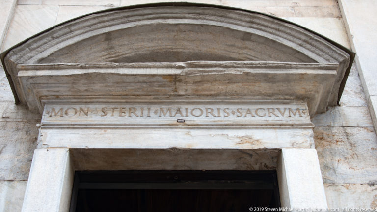 Stone doorway lintel with the carved Latin inscription MONASTERII MAIORIS SACRVM beneath a shallow arched molding.