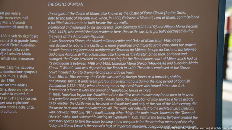 English-language interpretive panel titled The Castle of Milan, with text describing the history and reconstruction of Castello Sforzesco.