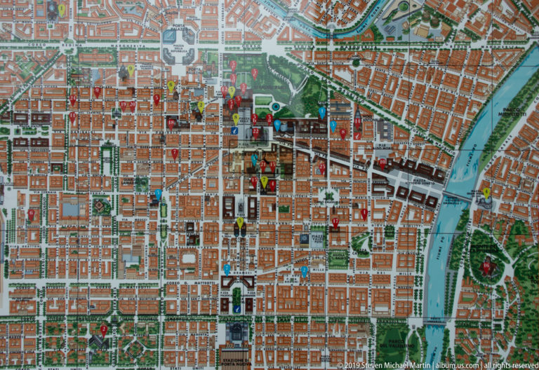 Detailed map of central Turin showing the street grid, Po River, parks, and numerous marked points of interest.