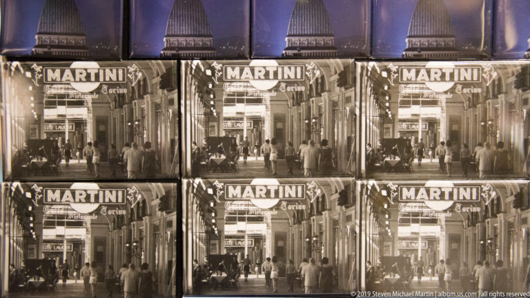 Grid of repeated vintage street photographs labeled “MARTINI” and “Torino” in a display.