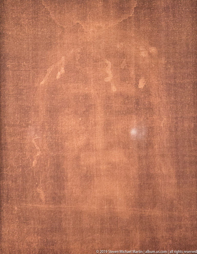 Close view of the faint sepia body image associated with the Shroud of Turin, showing subtle tonal traces across the cloth.