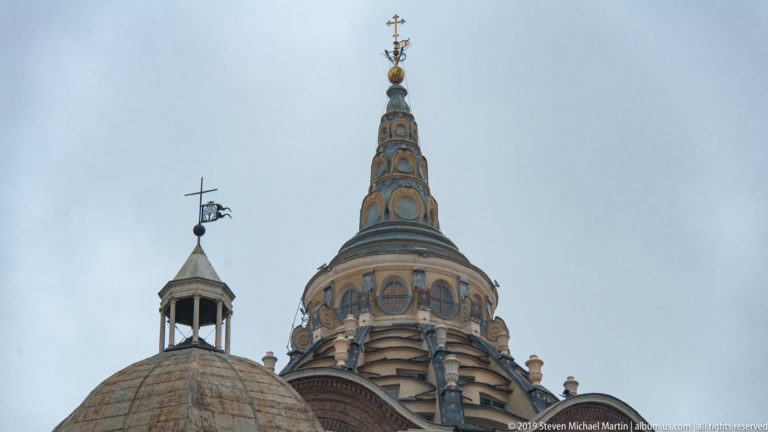 Ornate Shroud Chapel dome and tapering lantern topped by a globe and cross, beside a smaller ribbed dome.