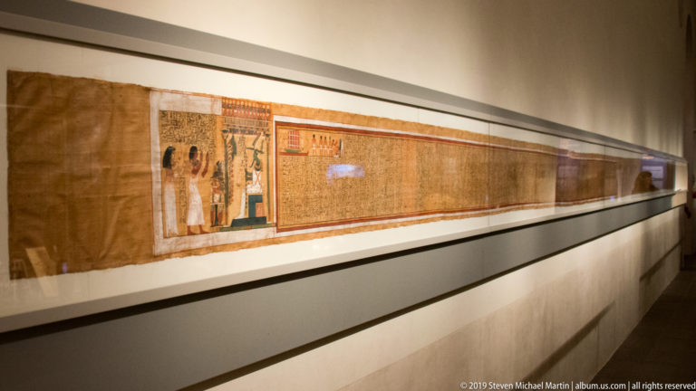 Long Book of the Dead papyrus of Kha displayed horizontally, with the opening Osiris vignette visible at the near end.