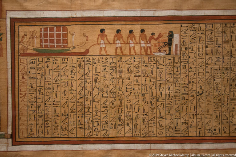 Section of Kha’s Book of the Dead with a coffin procession vignette above dense columns of cursive hieroglyphic text.