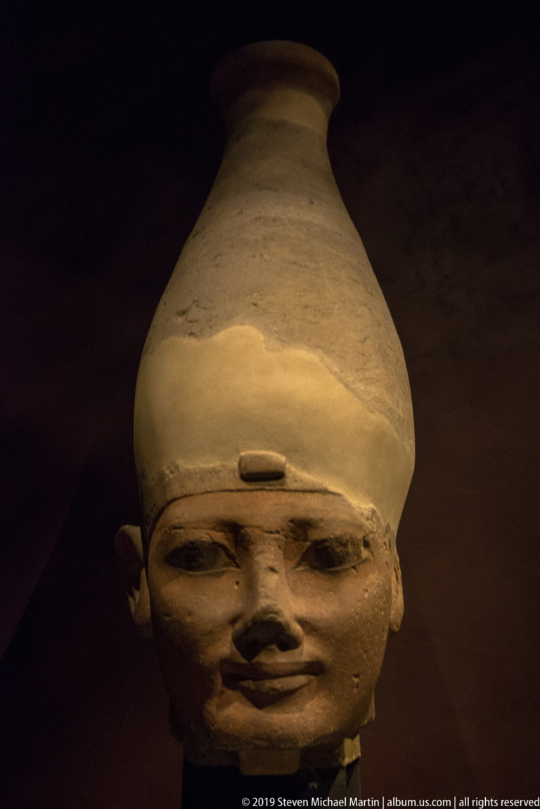 Sandstone head of Thutmose I wearing the tall White Crown of Upper Egypt, broken at the neck.