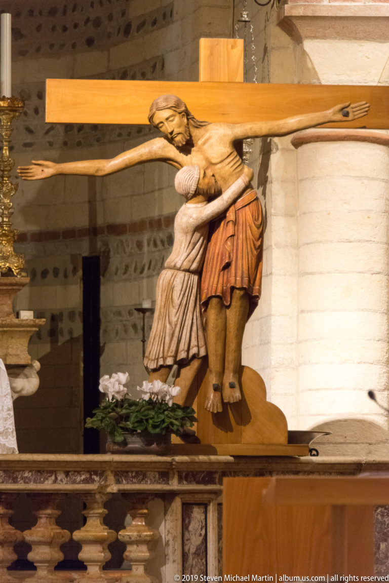 Polychrome Crucifixion group with Christ on the cross and mourning attendant figures inside San Lorenzo.