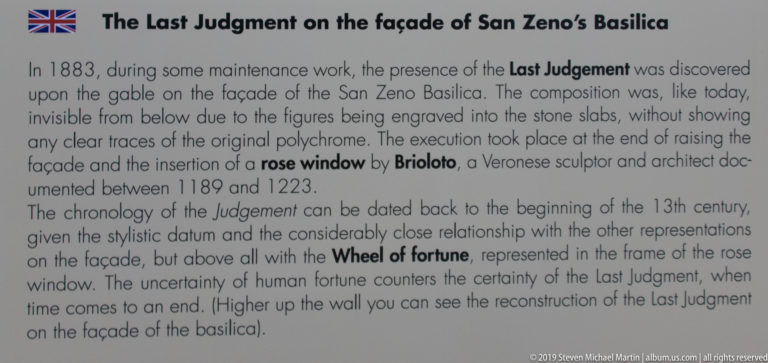Museum-style text panel titled about the Last Judgment on the facade of San Zeno Basilica.