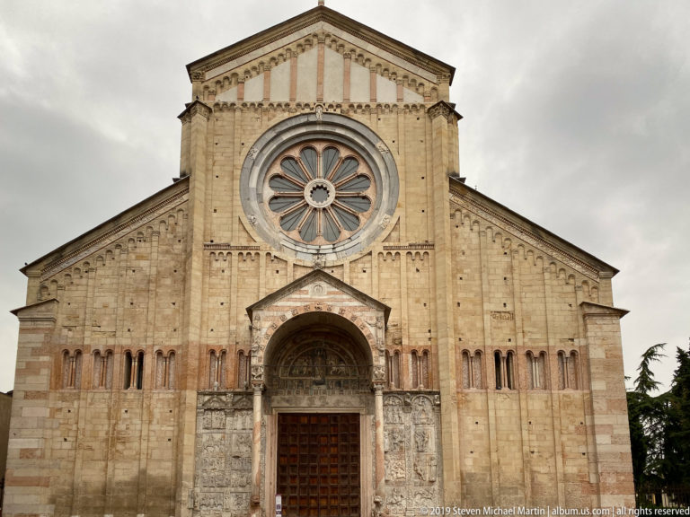 Closer view of San Zeno’s upper west façade centered on the wheel window above the entrance porch.